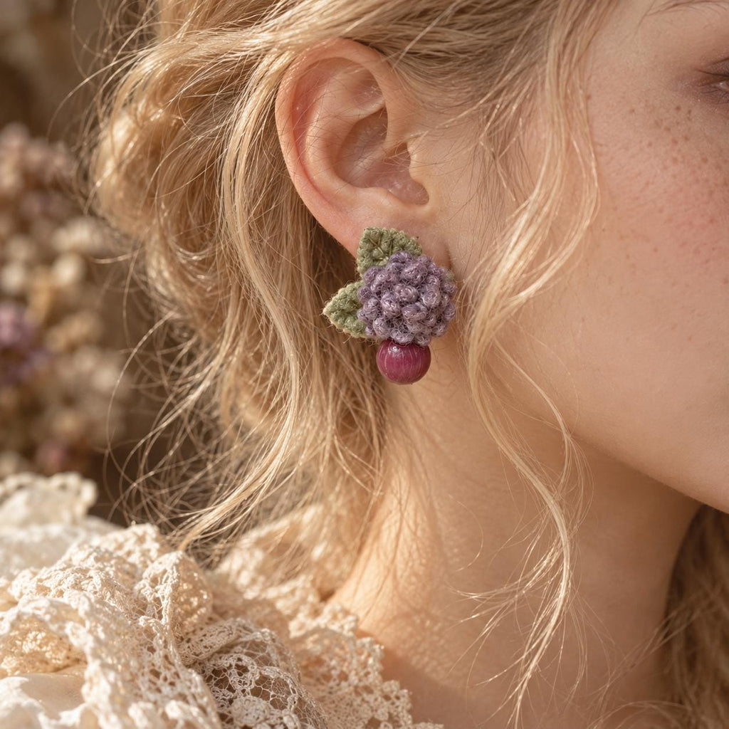Lilac Berry crochet-flower earrings worn with an ivory lace blouse.